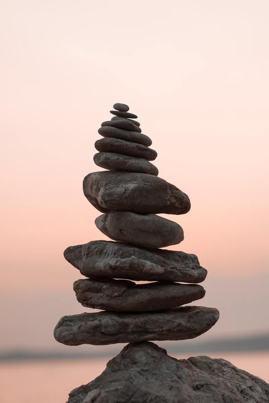 Stacked river rocks which is a mindfulness practice. This represents that Sacred Circle Holistic Healing offers mindfulness-based online therapy anywhere in Kansas. 