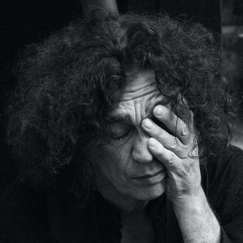 Black and white picture of an older man crying, his face in his hands. This repicts the intense feelings that come along with grief. Sacred Circle Holistic Healing offers grief support services for adults in Kansas.