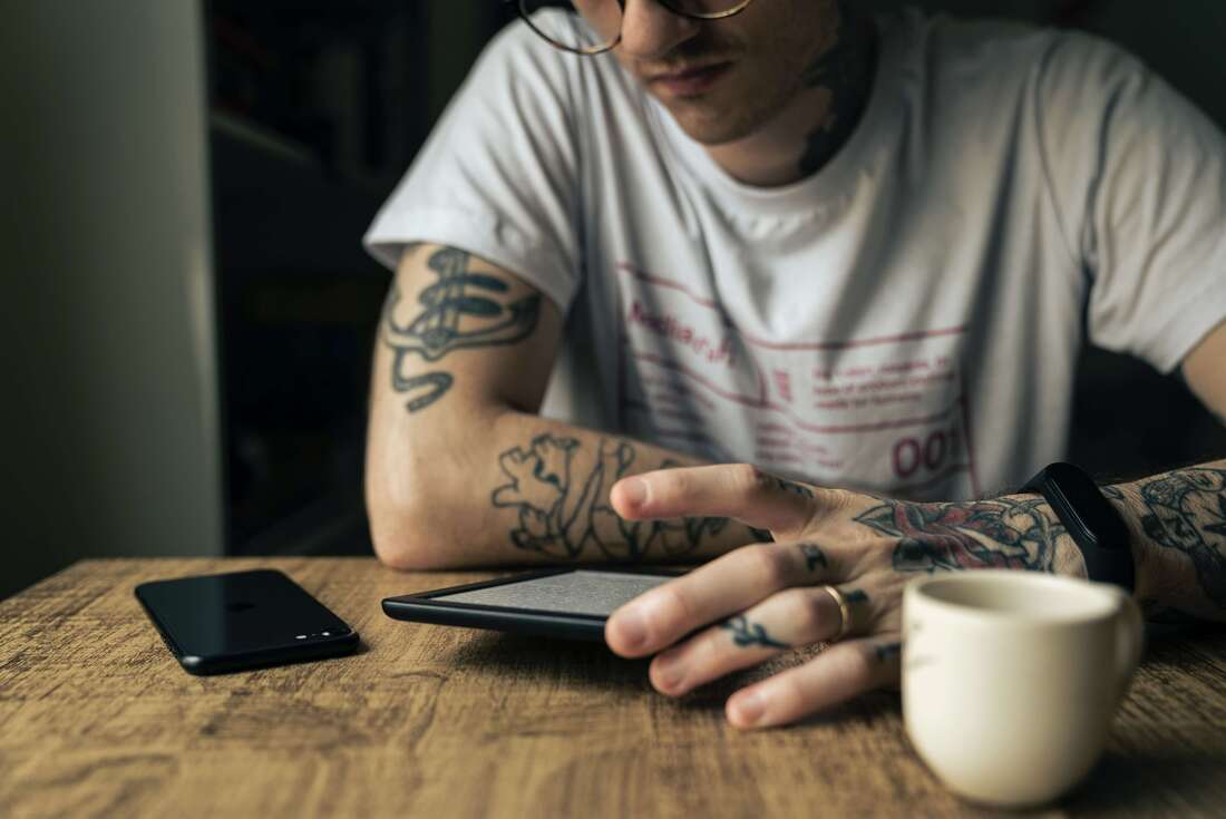 Young man with tattoos representing the young adult clients that come for online Holistic Life Coaching.