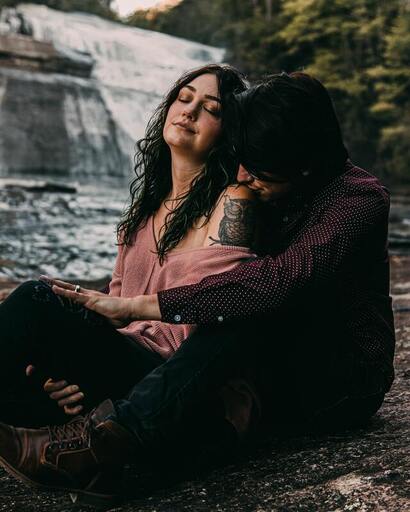 Picture of a young woman sitting and leaning against a young man who has his arms around her. This illustrates that Sacred Circle Holistic Healing offers online therapy in Kansas for codependency and low self-esteem.